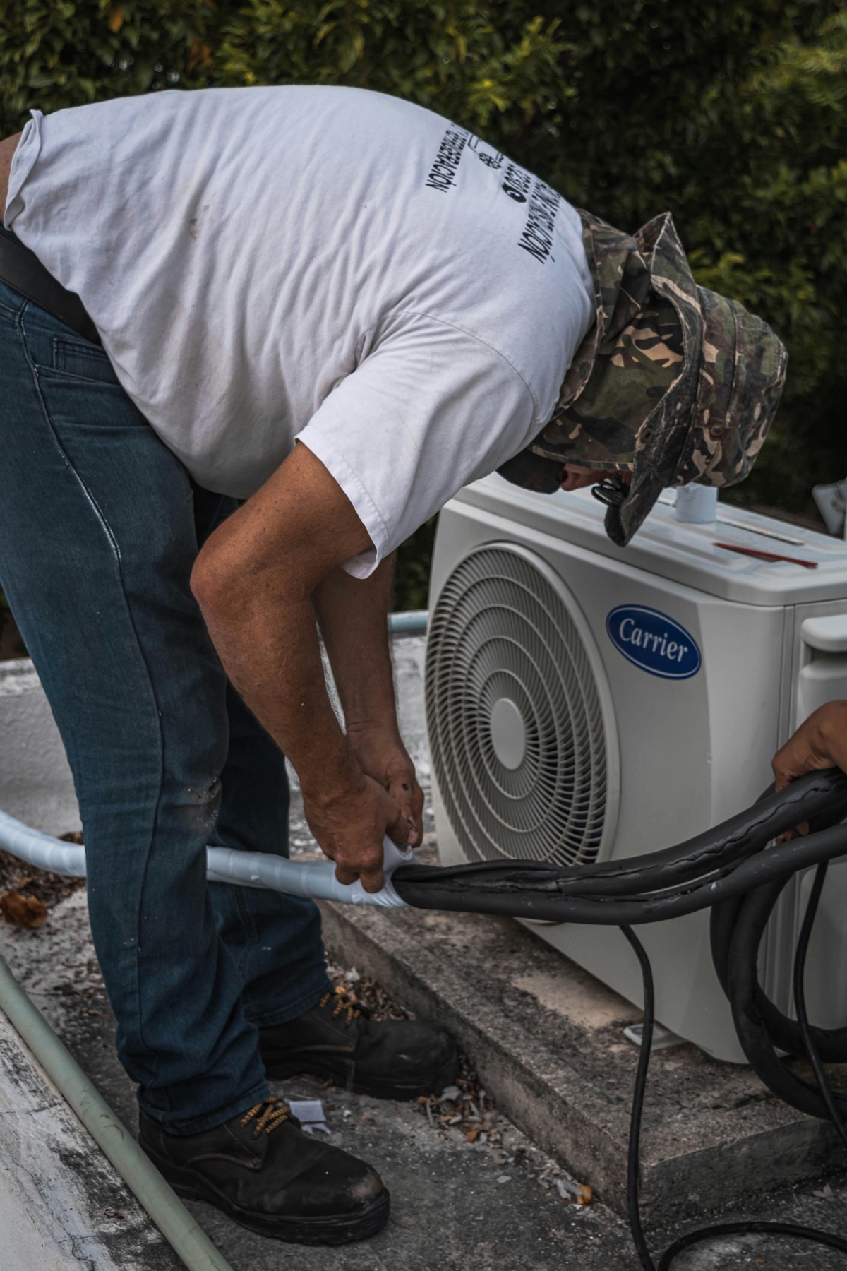 HVAC technician installing an outdoor AC system