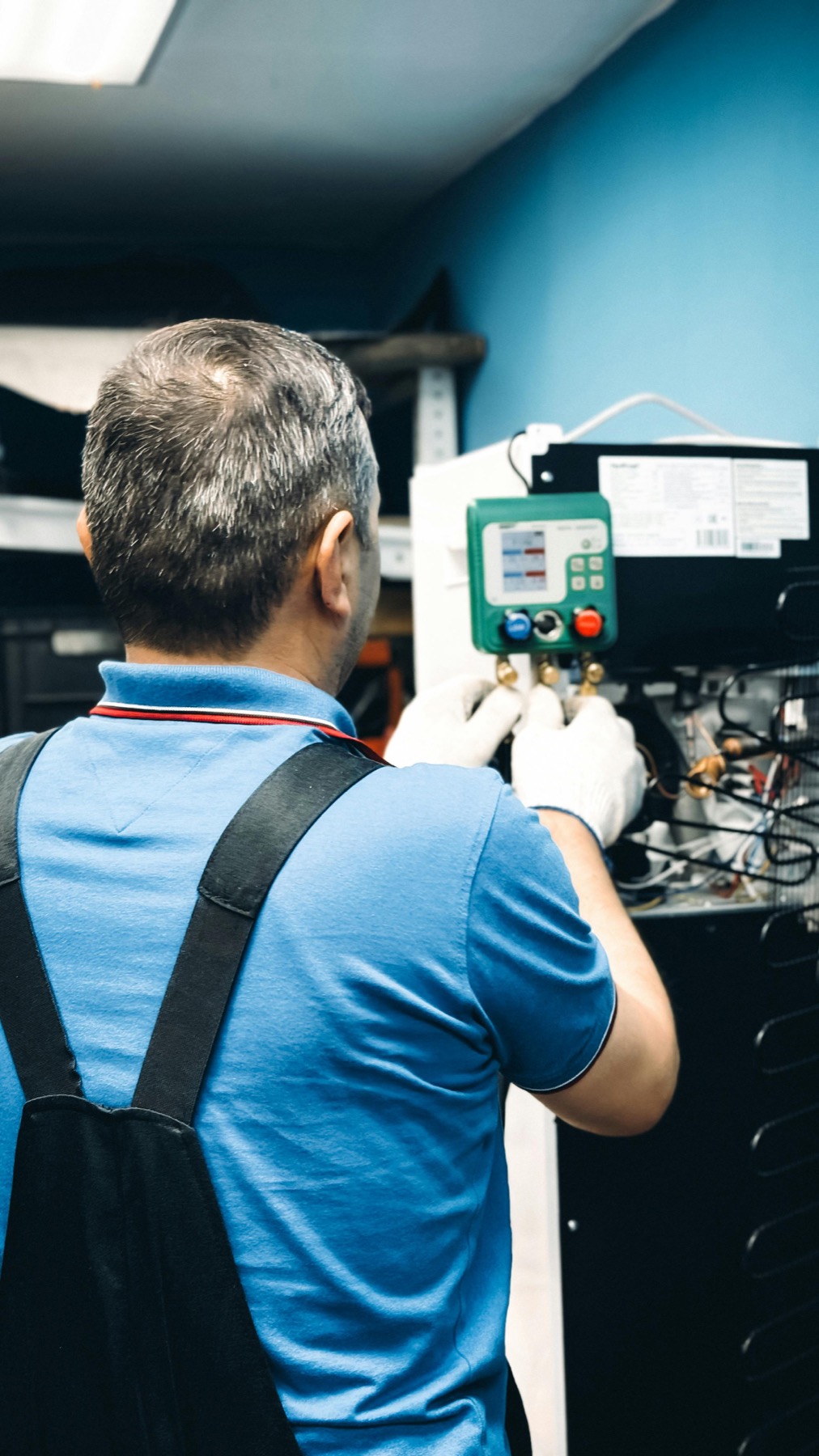 HVAC technician servicing indoor heating and cooling equipment